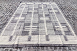 Close-up of grey beige weave and fringe detail