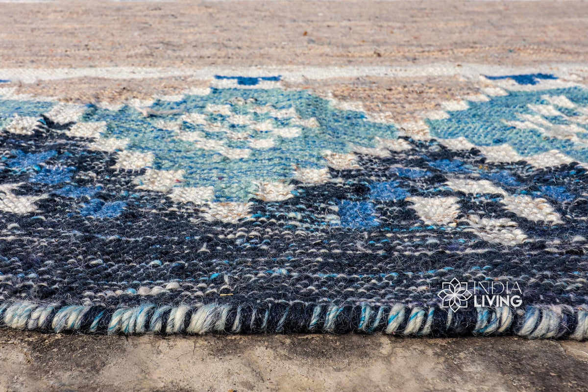 Blue oval indoor outdoor rug on a covered porch