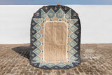 Blue oval rug styled on a patio