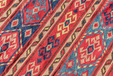Red Afghan style kilim rug styled as a patio rug