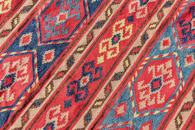 Red Afghan style kilim rug styled as a patio rug