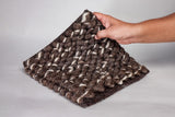 Close-up of chunky wool loop pile texture in brown and ivory