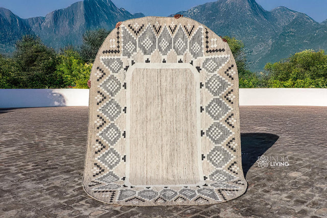 Beige oval rug styled on a patio