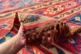 Red Afghan style kilim rug folded for shipping