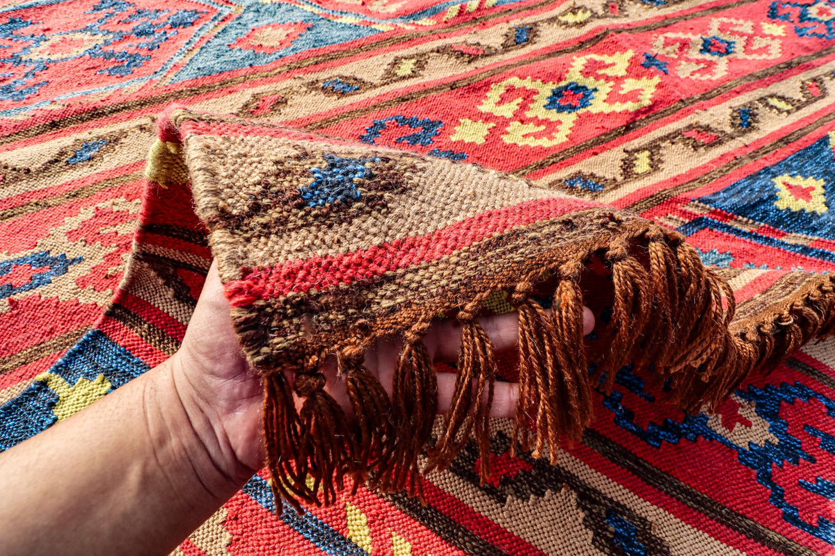 Red Afghan style kilim rug folded for shipping