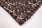 Brown ivory wool rug shown under a coffee table
