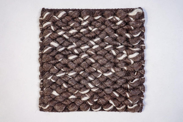 Brown ivory wool loop rug styled in a living room