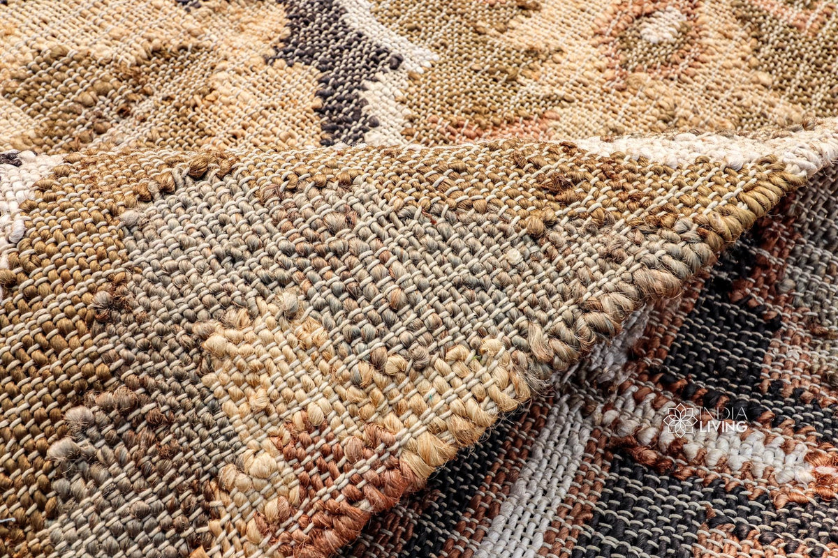 Reversible jute rug shown rolled to display both sides
