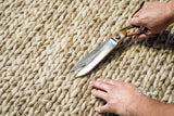 Beige braided wool rug in a bedroom setting