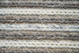 Chunky knit wool rug styled in a living room setting