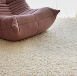 Ivory wool rug styled in a living room setting