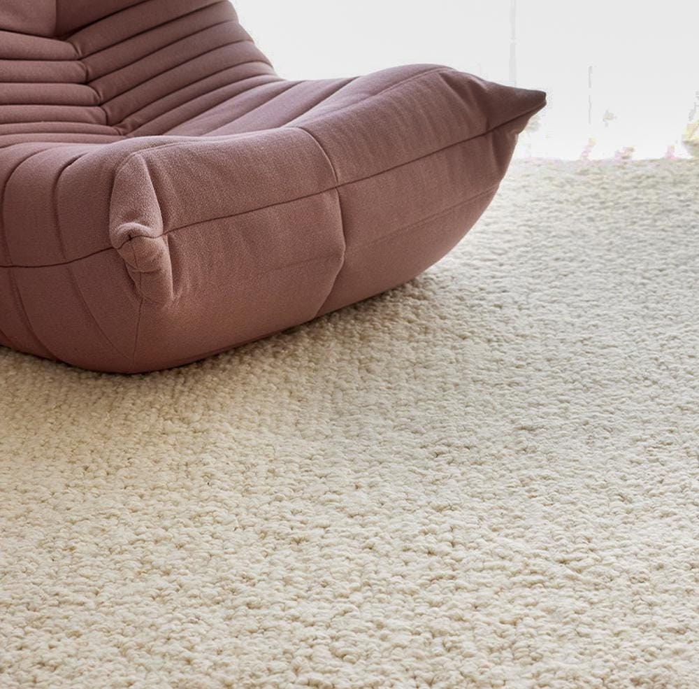 Ivory wool rug styled in a living room setting