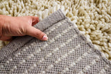 Ivory shaggy rug styled near a bed