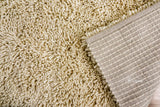 Close-up of ivory shag wool pile texture