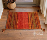 Orange kilim rug styled in a living room