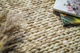 Beige braided wool rug corner detail