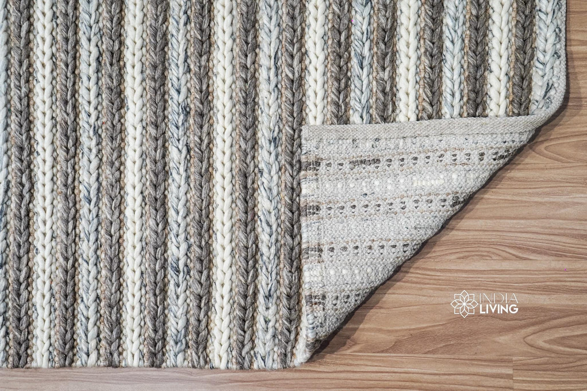 Brown grey ivory wool rug styled with a reading chair