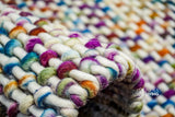 Full room view with rainbow basket knit rug