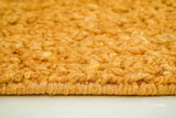 Corner detail of handwoven orange wool rug
