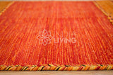 Overhead view of orange kilim rug