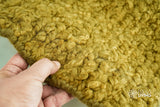 Olive green handwoven chunky wool rug, flat lay view