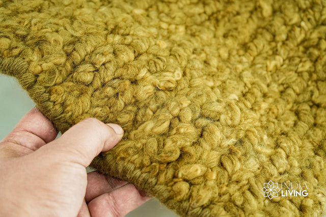 Olive green handwoven chunky wool rug, flat lay view