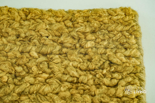 Olive green wool rug styled in a living room