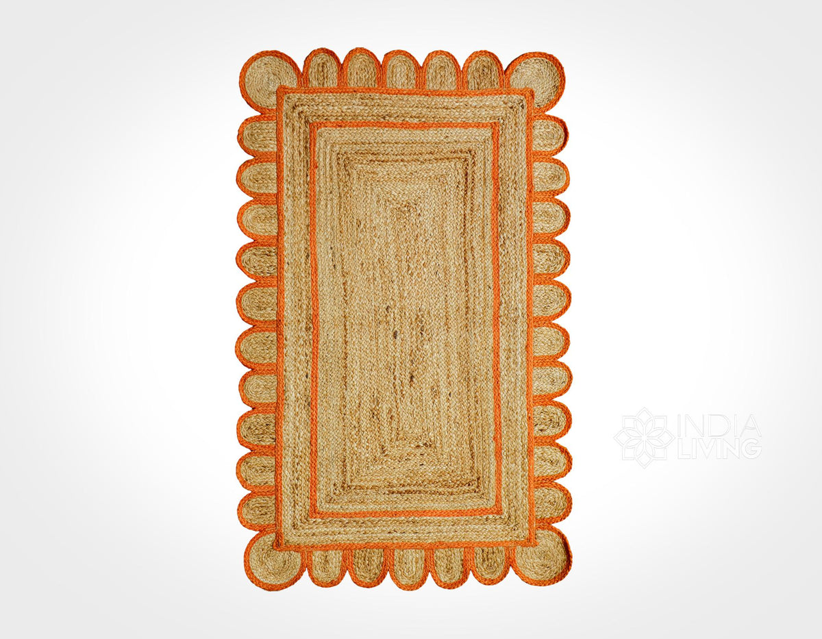 Orange braided jute rug styled in an entryway