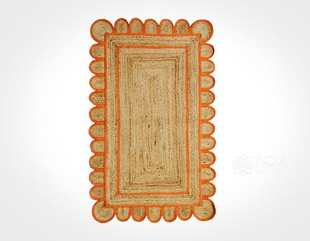 Orange braided jute rug styled in an entryway