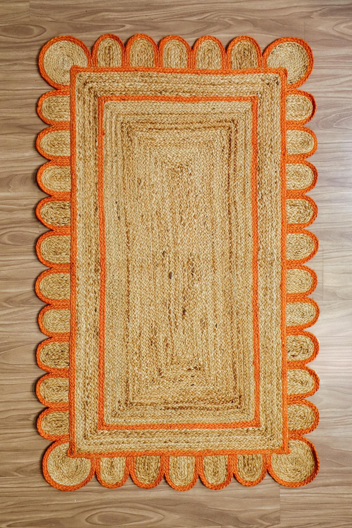 Orange jute rug rolled to show thickness and edge