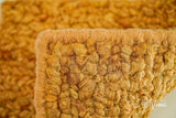 Orange wool rug edge and binding detail