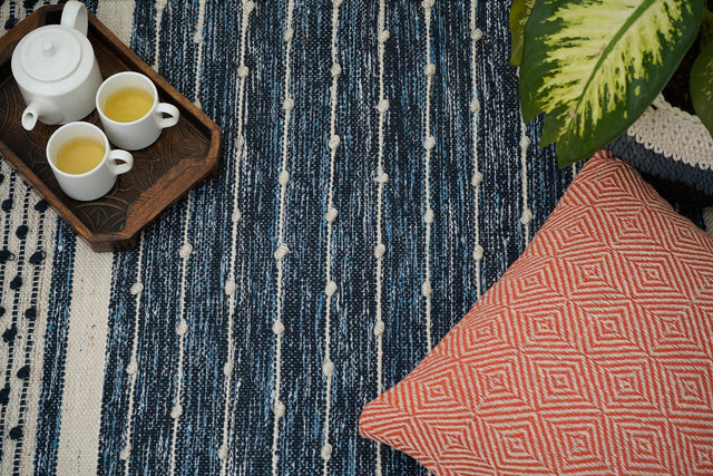 Dark denim blue kilim rug flat lay showing full tasseled design