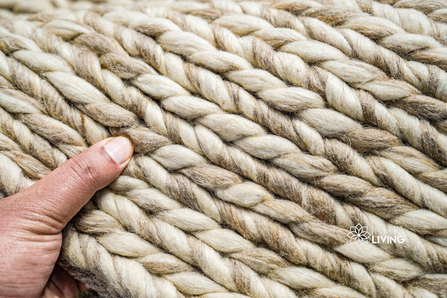 Beige braided wool rug styled in a Scandinavian living room