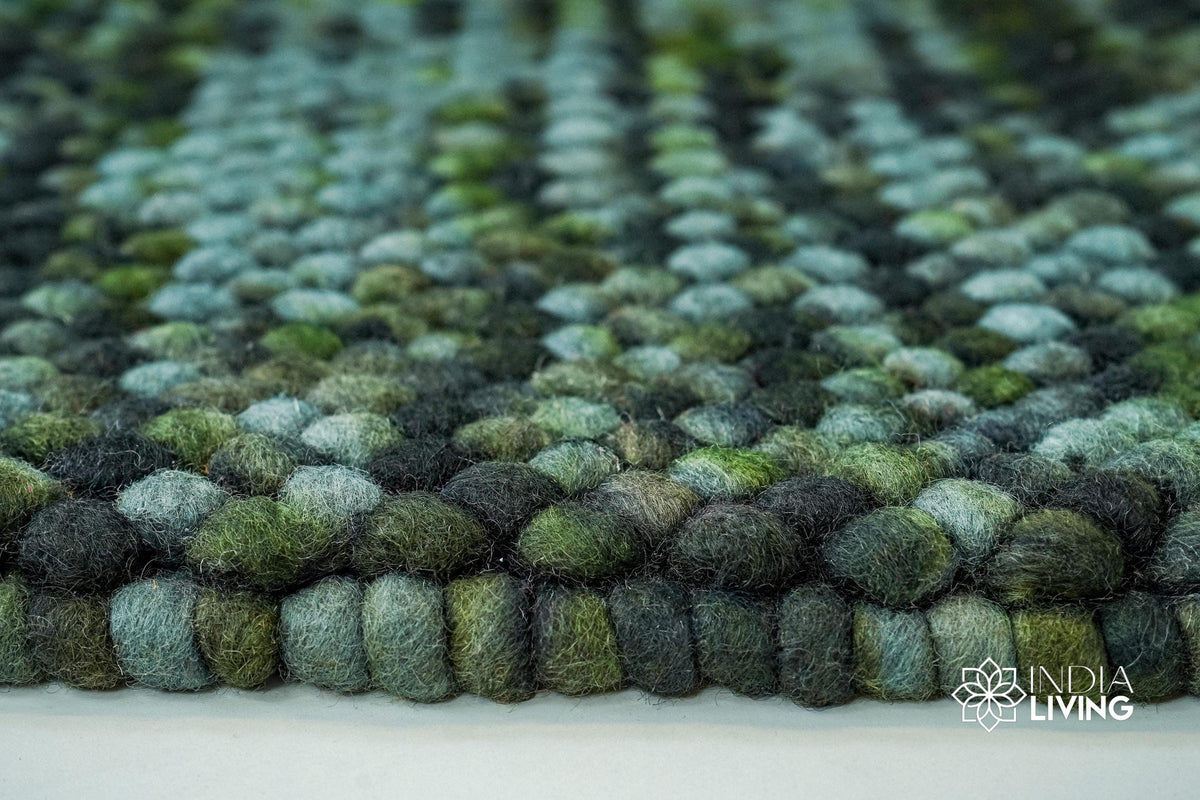 Moss green felted wool rug in a living room styling
