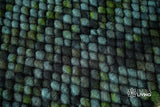 Moss green wool rug shown with pet nearby