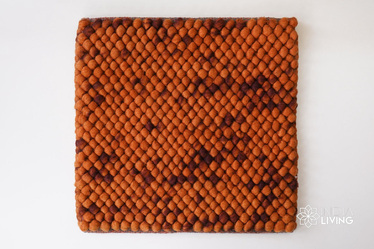 Rust orange wool rug styled in a living room