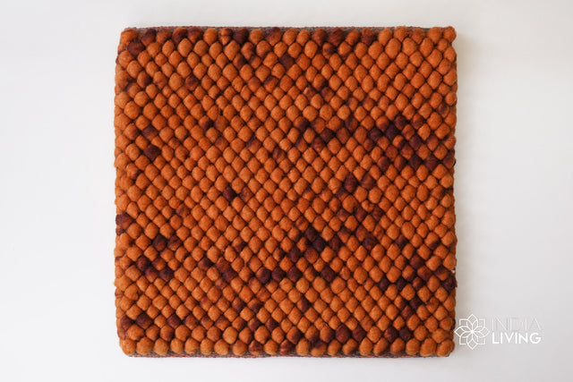 Rust orange wool rug styled in a living room