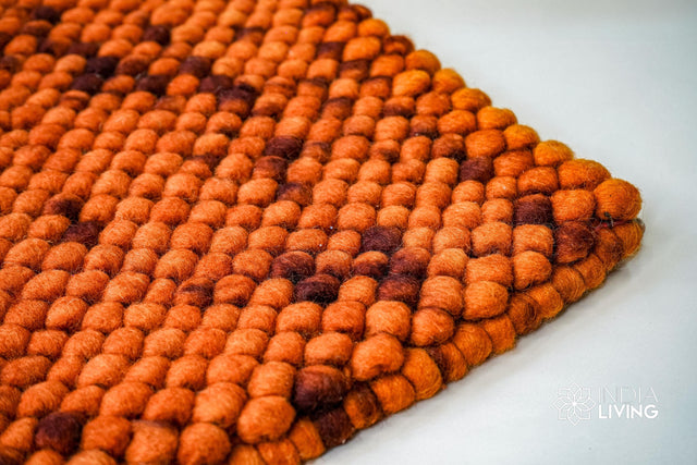 Rust orange felted wool rug, flat lay view