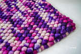 Purple wool rug in a bedroom decor setting