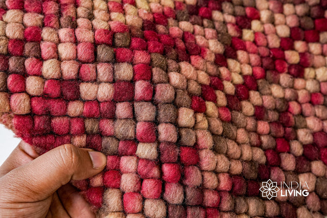 Beige red wool loop rug styled in a living room setting
