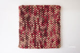 Beige red wool rug corner detail showing reversible edge
