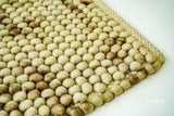 Coffee beige wool rug in a Scandinavian bedroom setting