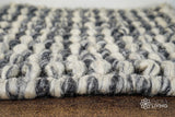 Grey wool rug shown under furniture