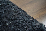 Black wool rug full room overhead view