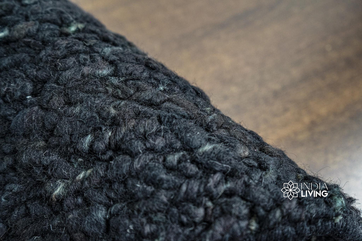Black wool rug full room overhead view