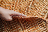 Orange jute round rug in a dining room setting