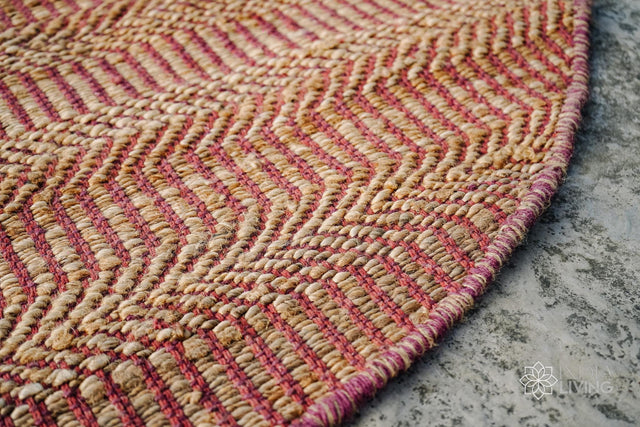 Pink jute round rug styled in a living room setting