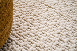 Natural ivory basket weave wool rug, flat lay view