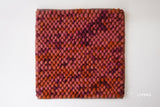 Colorful wool rug shown with pet nearby