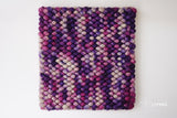 Corner detail of handwoven colorful wool rug